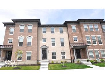 Charming brick townhouses feature well-maintained landscaping and inviting entrances at 954 Yorkshire Ln, Zionsville, IN 46077