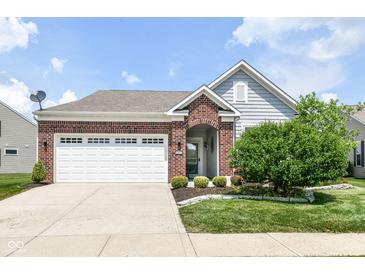 Charming single-story home featuring brick accents, a two-car garage, and a well-manicured front yard at 13427 Merryvale St, Fishers, IN 46037