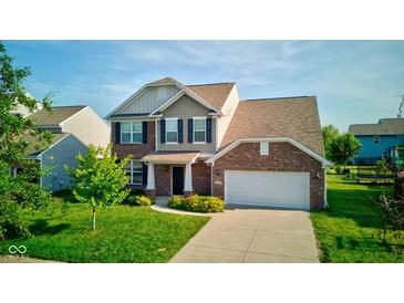 Inviting two-story home with brick and siding, featuring a well-manicured lawn and attached two-car garage at 14620 Hinton Dr, Fishers, IN 46037