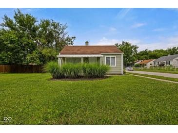 Charming home featuring a cozy, covered front porch and well-maintained lawn at 1730 S State Ave, Indianapolis, IN 46203