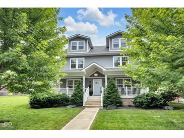 Charming gray two-story home with well-manicured lawn and inviting front porch at 3101 N Washington Blvd, Indianapolis, IN 46205