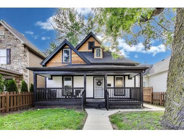 Charming home featuring a covered front porch and a well-maintained lawn, creating a welcoming curb appeal at 44 S Tremont St, Indianapolis, IN 46222