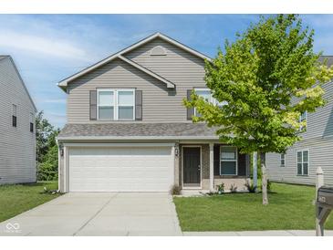 Charming two-story home with a two-car garage and a well-maintained front lawn at 5672 High Timber Ln, Indianapolis, IN 46235