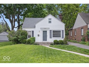 Charming single-Gathering home with a well-manicured lawn and a classic white facade at 6009 Ralston Ave, Indianapolis, IN 46220