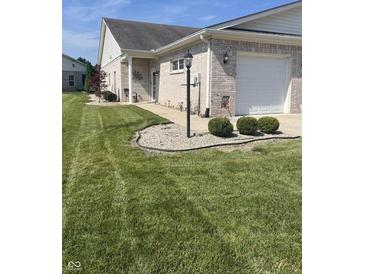 Beautiful brick home with a well-maintained lawn and attached garage at 712 Disciples Way, Greenwood, IN 46143