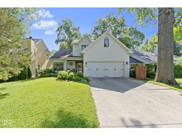 Charming home with a two-car garage, well-maintained lawn, and beautiful trees at 111 N 8Th St, Zionsville, IN 46077