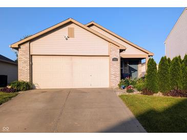 Charming single-story home with a well-maintained lawn and an attached two-car garage at 1823 Long Lake Dr, Greenwood, IN 46143