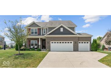 Charming two-story home featuring a brick facade, three-car garage, and well-manicured front lawn at 3679 Woodruff Pl, Bargersville, IN 46106