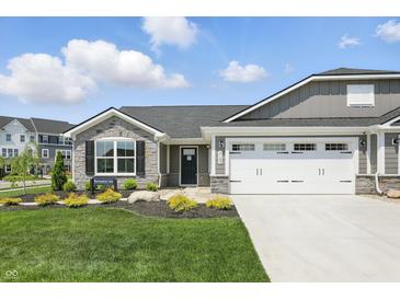 Charming single-story home featuring stone accents, gray siding, a well-manicured lawn, and a two-car garage at 4182 Hume Ave, Plainfield, IN 46168