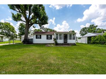 Charming home featuring a well-manicured lawn and beautiful, mature tree offering shade at 4639 Terrace Ave, Indianapolis, IN 46203