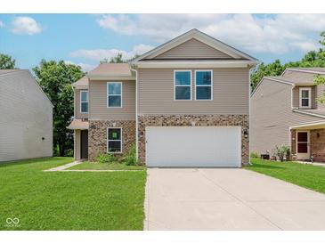 Two-story home with a two car garage, brick accents, well-kept lawn, and neutral colored siding at 8248 Ossian Ct, Camby, IN 46113