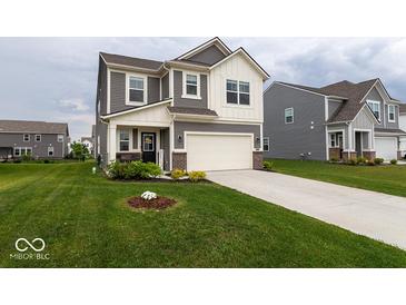 Beautiful two-story home boasts a well-manicured lawn, neutral siding, and an attached two-car garage at 9309 Kellner St, Pendleton, IN 46064