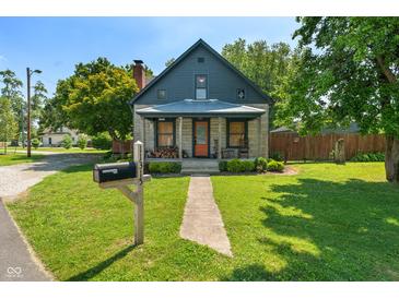 Charming home featuring stone accents, a covered porch, and a well-manicured lawn with a mailbox at 11315 House St, Indianapolis, IN 46259