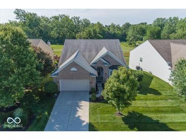 Charming brick home with a well-manicured lawn and mature trees in a peaceful residential neighborhood at 13161 Duval Dr, Fishers, IN 46037