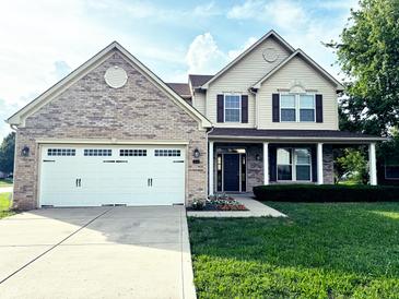 Charming two-story home featuring a brick and siding facade, well-manicured lawn, and a two-car garage at 2444 Cole Branch Ct, Indianapolis, IN 46239