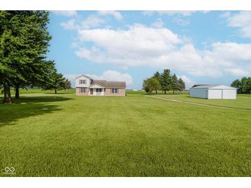 Charming two-story brick and vinyl home with large lawn and detached garage at 4330 S 100 E, Lebanon, IN 46052