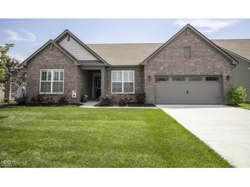 Charming single-story brick home featuring a well-manicured lawn and attached two-car garage at 5081 Holborn Ave, McCordsville, IN 46055