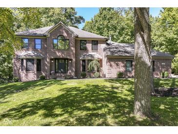 Beautiful brick home with a well manicured lawn and mature trees at 5826 Winding Way Ln, Indianapolis, IN 46220