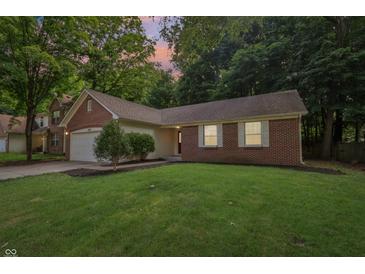 Charming brick home with a well-manicured lawn and mature trees in a serene, quiet neighborhood setting at 5935 Oakforge Ln, Indianapolis, IN 46254