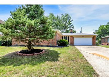 Charming brick ranch home with a lush front yard and a welcoming two-car garage at 734 Summitcrest Dr, Indianapolis, IN 46241