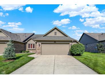 Charming single-story home with a two-car garage, complemented by lush greenery and a well-maintained lawn at 785 Cottage Ln, Greenwood, IN 46143