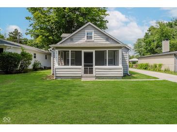 Charming bungalow-style home with a screened-in front porch and well-maintained lawn at 8912 Robey Dr, Indianapolis, IN 46234