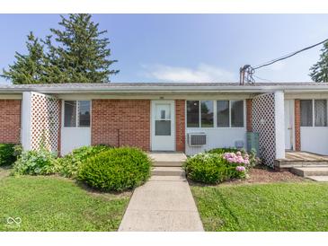 Charming brick apartment with well-maintained landscaping, inviting front entry, and manicured lawn at 951 W Mckay Rd, Shelbyville, IN 46176