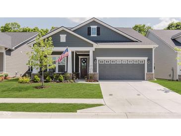 Charming single-Gathering home with gray siding, manicured lawn, and a welcoming two-car garage at 10725 Crum Ct, Fishers, IN 46037