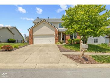 Charming two-story home with a well-manicured lawn, brick accents, and an attached two-car garage at 1260 Easton Point Dr, Greenwood, IN 46142