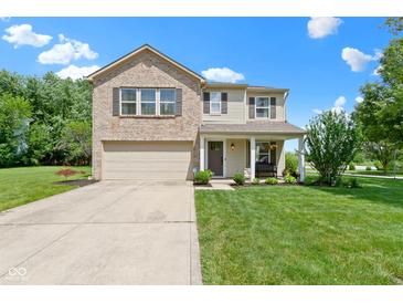 Charming two-story home with a brick and vinyl exterior, attached garage, front porch, and well-maintained lawn at 14754 Drayton Dr, Noblesville, IN 46062