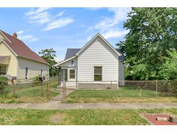 Charming home with white siding, a gray roof, and a small front yard with chainlink fence at 2400 Walnut St, Anderson, IN 46016