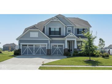 Beautiful two-story home with a well-manicured lawn and two-car garage at 5351 Rose Dr, Zionsville, IN 46077