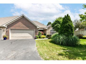 Charming brick home featuring a two-car garage and well-maintained landscaping at 6656 Easy St, Fishers, IN 46038