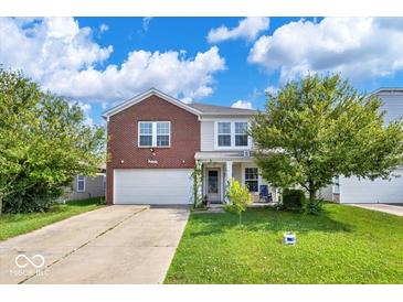 Charming two-story home with brick accents, a front yard, and attached garage at 951 Curlew Ln, Greenwood, IN 46143