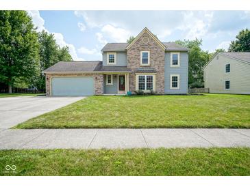Charming two-story home with a well-maintained lawn and a blend of siding and brick facade at 10751 Sheffield Ct, Fishers, IN 46038
