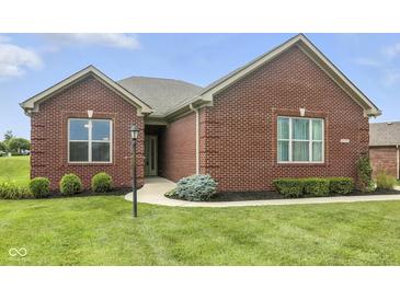 Charming brick home featuring well-manicured lawn and landscaped garden at 1127 Kay Dr, Greenwood, IN 46142