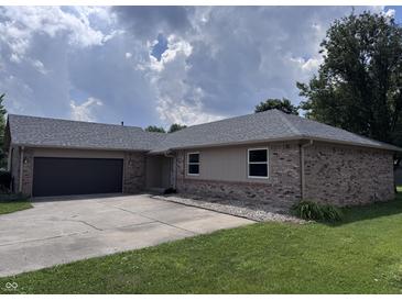 Charming single-story brick home featuring an attached garage and well-maintained lawn at 1206 Brownswood Dr, Brownsburg, IN 46112