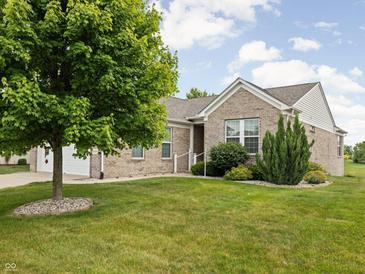 Charming brick home with lush green lawn, mature tree, and white trim at 13019 Pinner Ave, Fishers, IN 46037