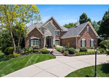 Charming brick home featuring a stone entryway and manicured landscaping at 14027 Waterway Blvd, Fishers, IN 46040