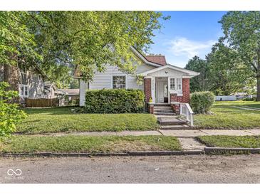 Charming home featuring a well-maintained lawn, inviting front porch, and classic architectural details at 2020 N B St, Elwood, IN 46036