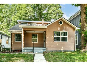 Charming single-story home with well-kept landscaping and a welcoming front porch at 2136 Ringgold Ave, Indianapolis, IN 46203