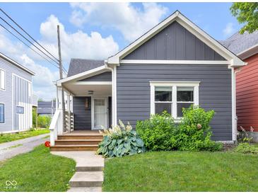 Charming home with a well-maintained lawn and a welcoming front porch at 329 Parkway Ave, Indianapolis, IN 46225