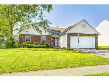 Charming one-story home with manicured lawn and two-car garage on a sunny day at 431 Alton Dr, Greenwood, IN 46143