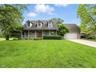 Charming brick home featuring a welcoming front porch and well-maintained landscaping at 1013 Chapman Blvd, Greenfield, IN 46140
