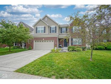 Charming two-story home featuring a brick and vinyl exterior, attached two-car garage, and well-manicured lawn at 13884 Wendessa Dr, Fishers, IN 46038