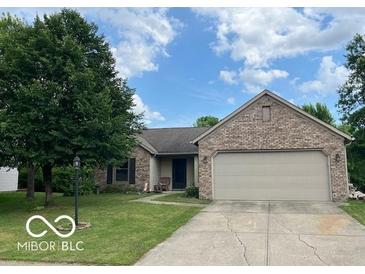 Charming brick ranch home with an attached two-car garage and lovely, mature landscaping at 17717 Cedarbrook Dr, Westfield, IN 46074