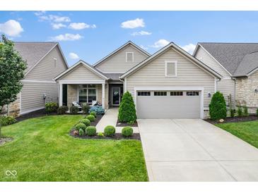 Charming home showcasing a manicured lawn and inviting front porch with stone accents and two-car garage at 2246 Heather Glen Way, Franklin, IN 46131