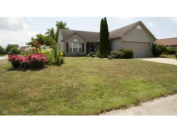 Charming single-Gathering home features a well-manicured lawn and colorful flower beds at 291 Lakemoore St, Brownsburg, IN 46112