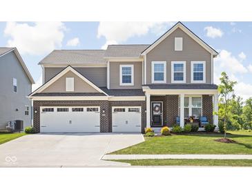 Charming two-story home with brick accents, a well-manicured lawn, and a spacious two-car garage at 3969 Canning St, Danville, IN 46122