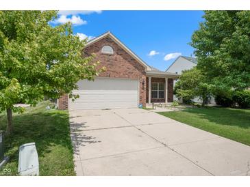 Charming brick home with well-maintained lawn, long driveway, and attached two-car garage at 452 Southern Pines Dr, Whiteland, IN 46184